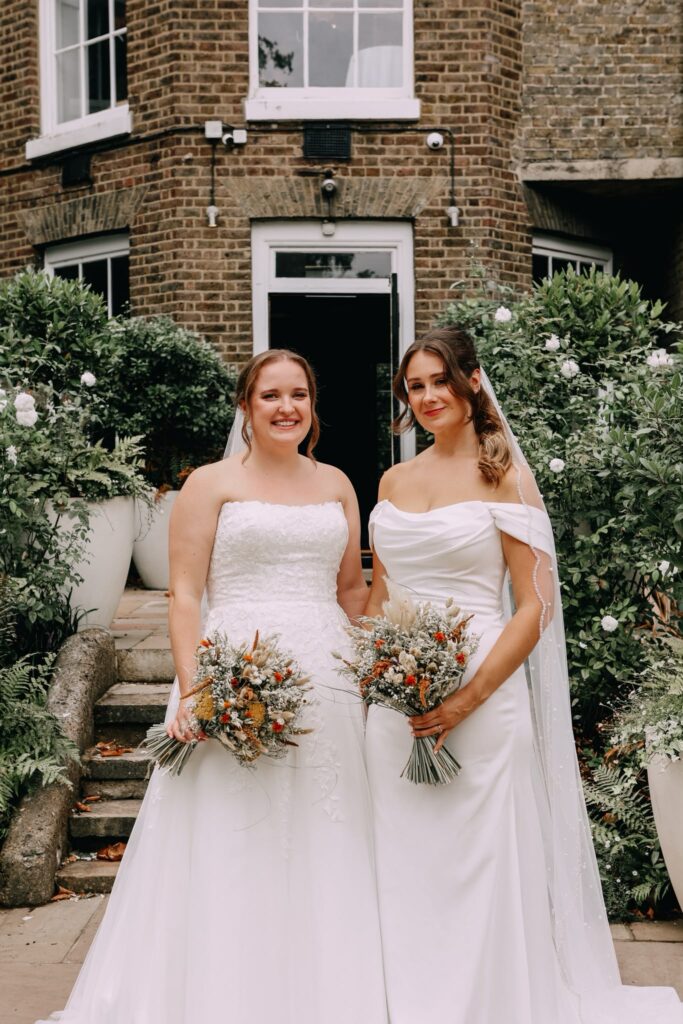 Two brides in their altered WED2B wedding dresses after bridal alterations for a Fulham wedding