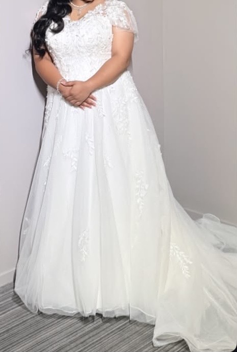 Hayes wedding dress alterations on an Essense of Australia D3529 gown with a redesigned lace neckline and illusion shoulders bride on wedding day.
