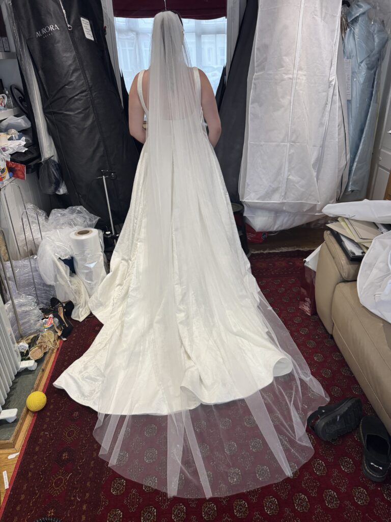 Oxted bride wearing her ivory WED2B Sofia Cruz Florentina ballgown after bridal alterations in Sutton, Surrey view of the cathedral veil
