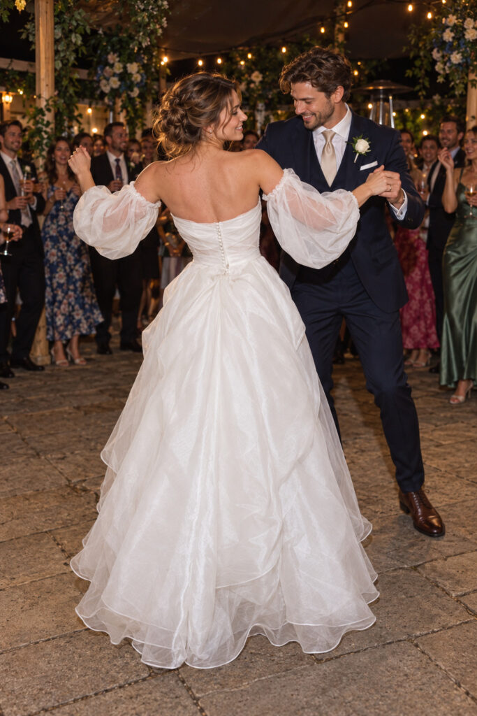 Dancing bride and groom back bustle