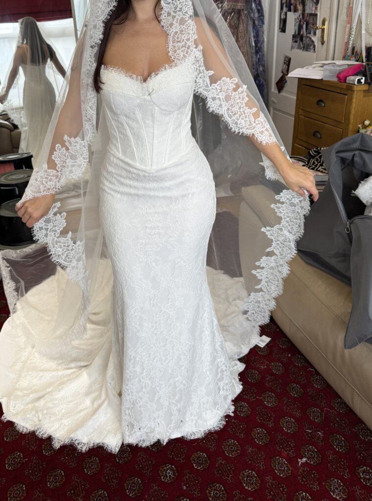 WONA Concept Bronx lace wedding dress, showcasing the fitted silhouette, dramatic train and lace-edged veil at the final fitting my Sutton Studio for this Cobham bridal alterations.