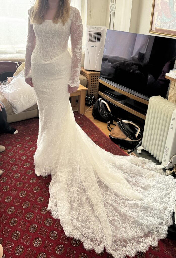 Beautifully fitted Maggie Sottero Ariadne bridal gown with long lace sleeves, veil and sweeping train at final fitting at my Greater London Studio.