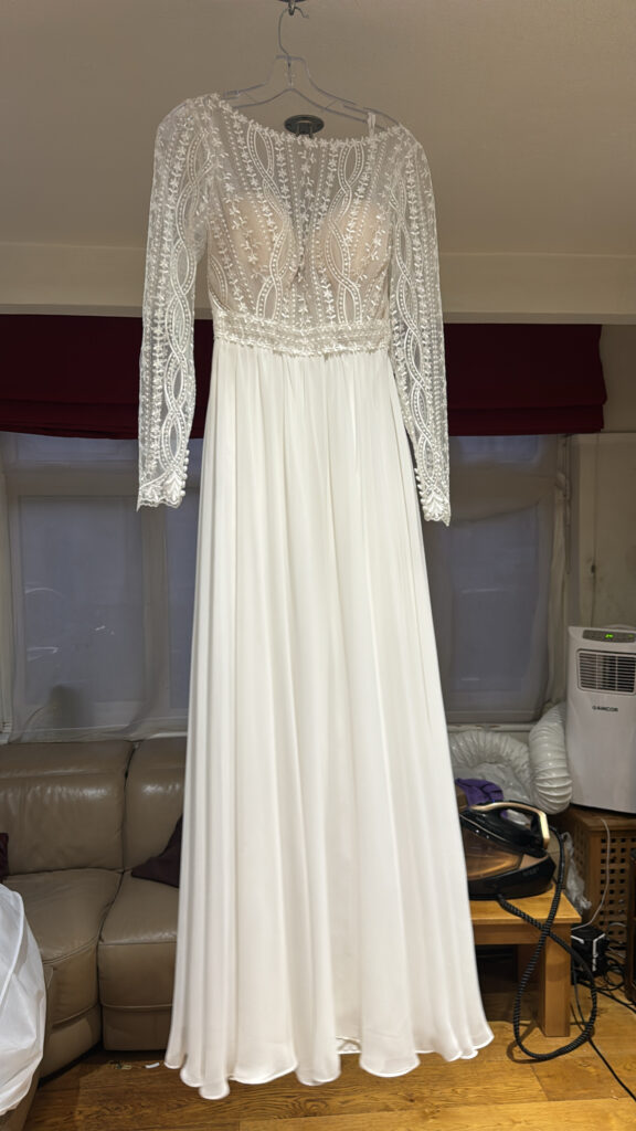 Heidi Hudson Marisol gown hanging in the studio after alterations and professional steam pressing