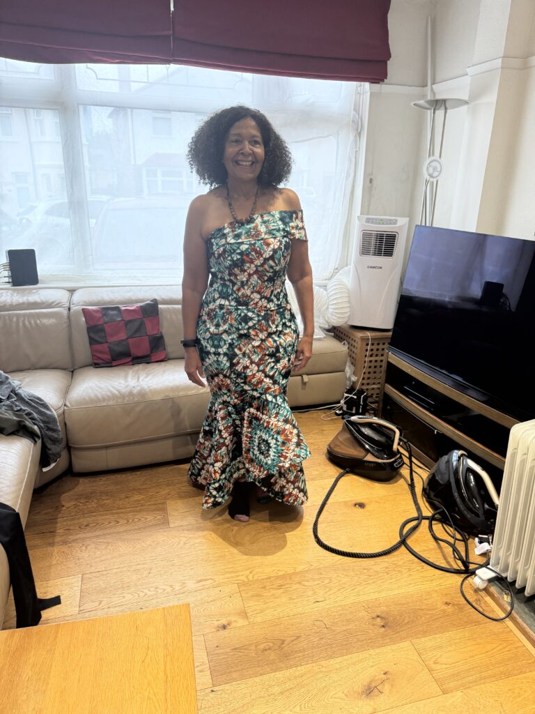Completed one-shoulder wax-print dress with a fitted silhouette and flared hem.