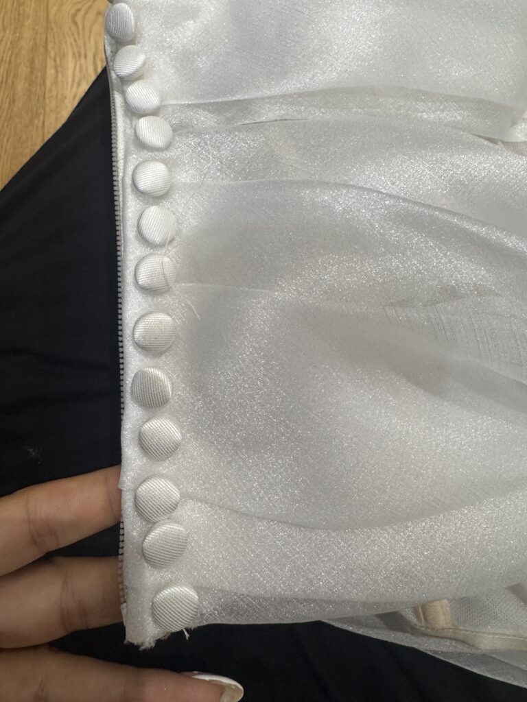 Daria Karlozi Wedding Dress Alterations including additional fabric covered buttons all along zip closure.