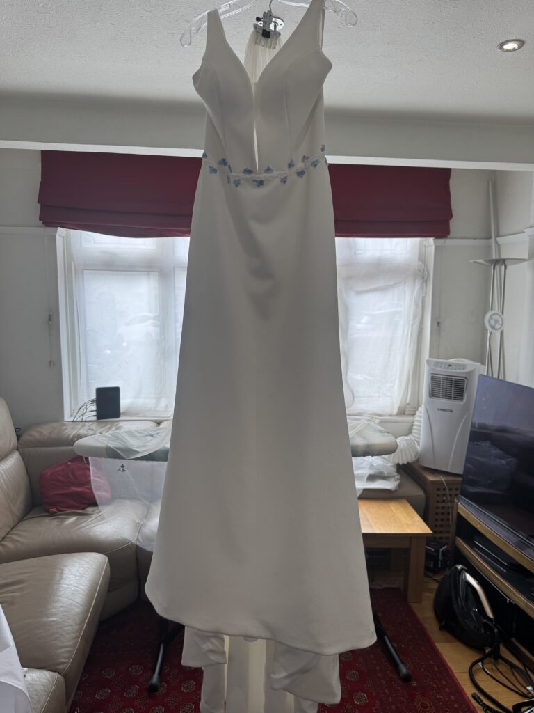 Bridal gown with altered waist detail, train and embroidered veil professionally steam pressed.