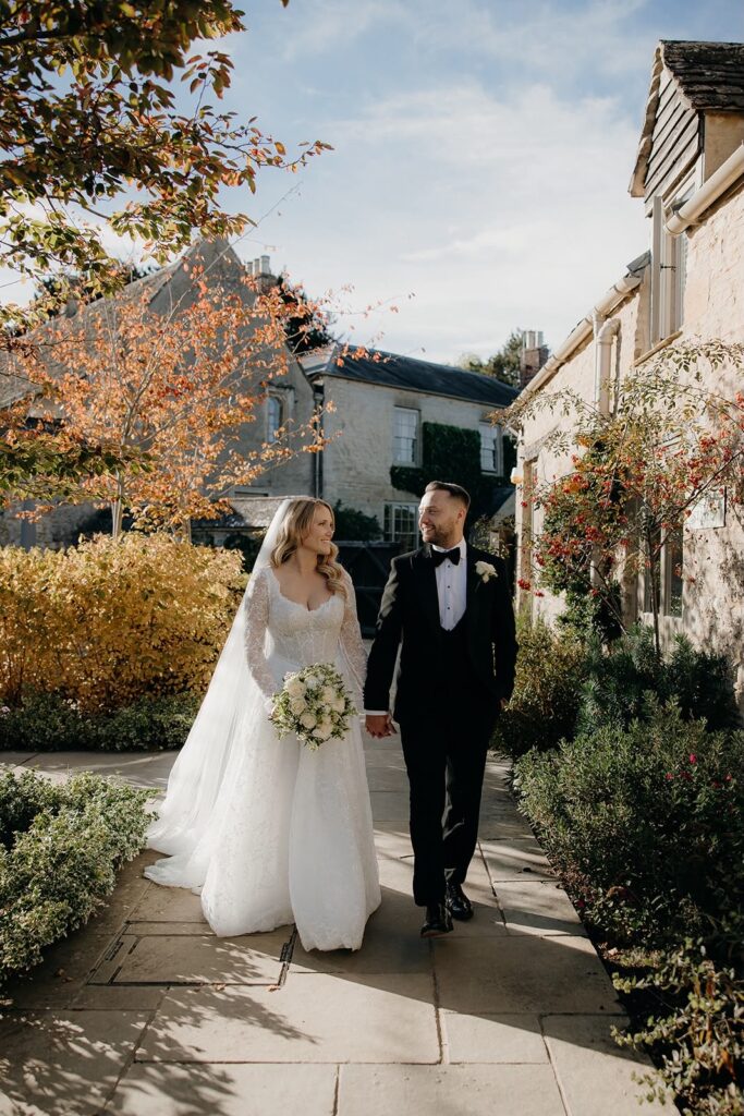 Banstead bride and groom walking together after alterations to her Morgan Davies Bridal Yedyna Estia gown.