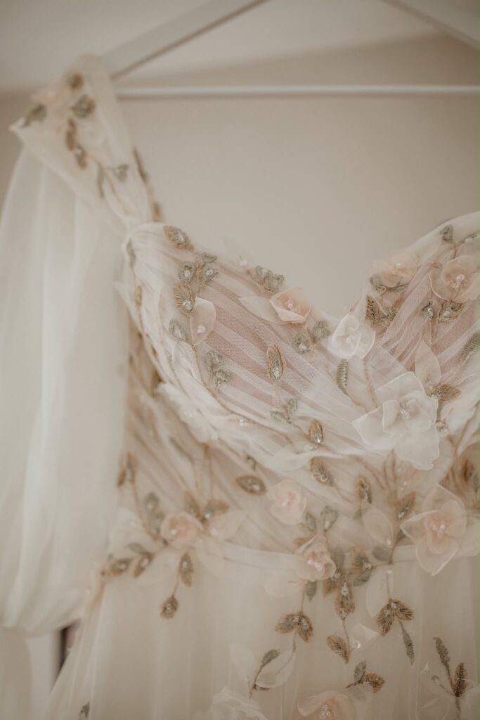 Raynes Park Morilee Bridal Alterations,Close-up of Morilee wedding dress featuring delicate three-dimensional flowers and embroidered sweetheart bodice