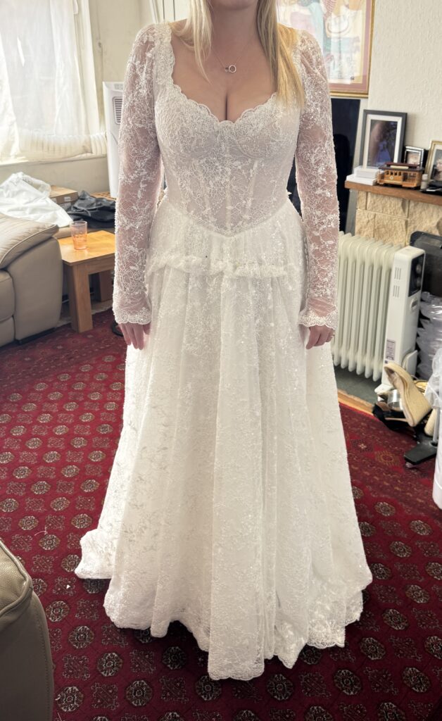 Yedyna Estia wedding dress fitting showing contoured bust and scalloped lace neckline at Sutton bridal alterations studio.
